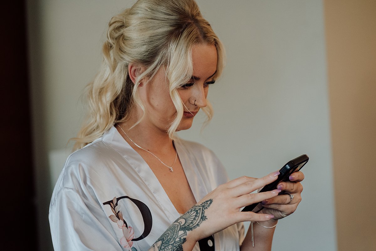 Bridesmaid checking her phone messages