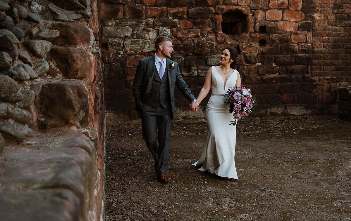 Bride and groom walking at the castle