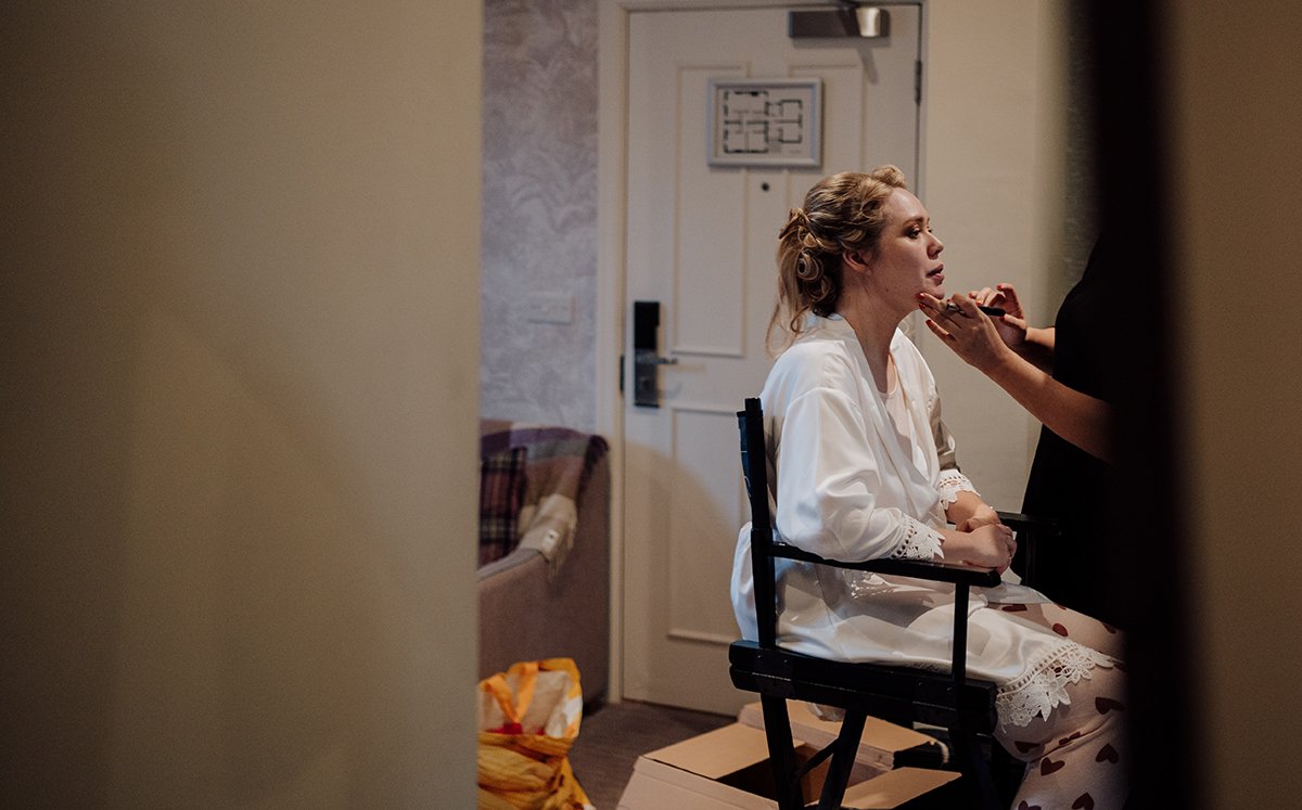 The bride having her makup and hair prepared