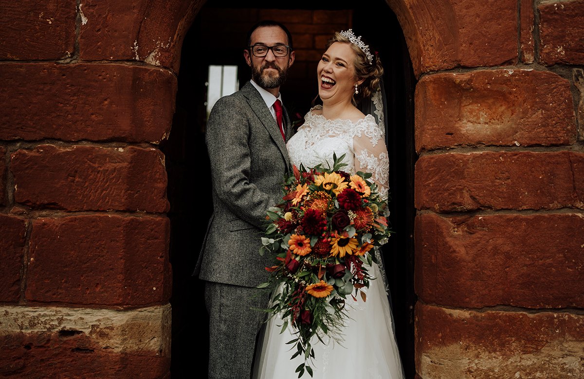 The bride and groom portraits standing in a door way