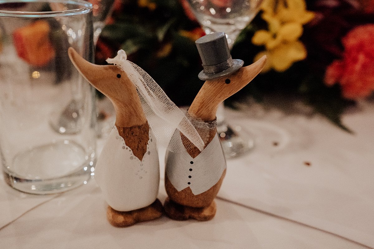Two wooden ducks on the top table