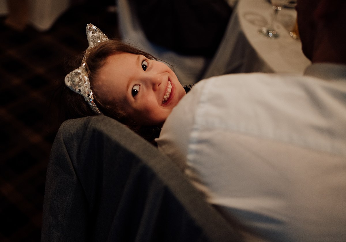 The flower girl peeping out from under a blanket