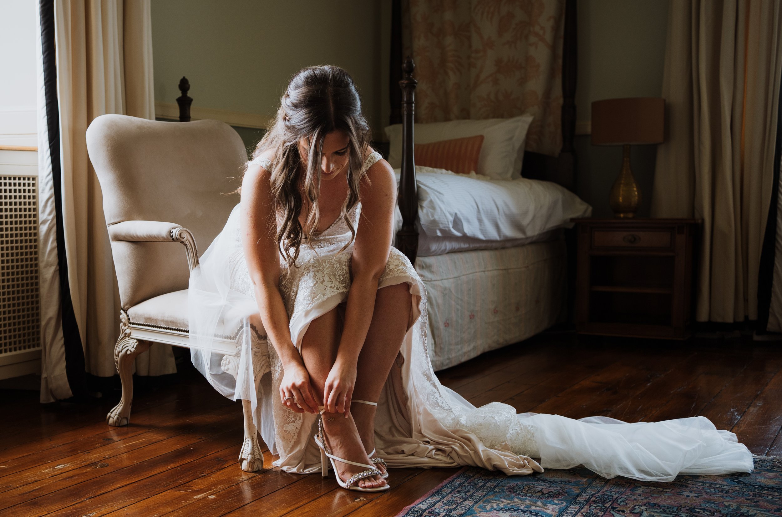 A bride fastening her shoes prior to the wedding ceremony