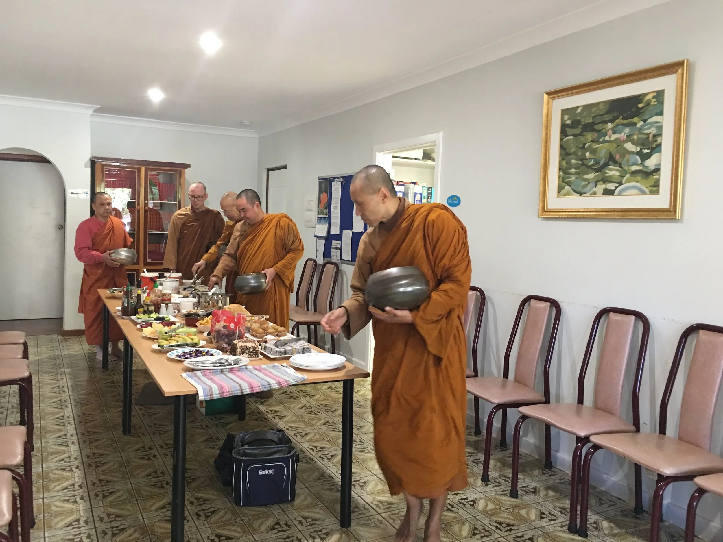 Monks taking dana in the Dining Room.