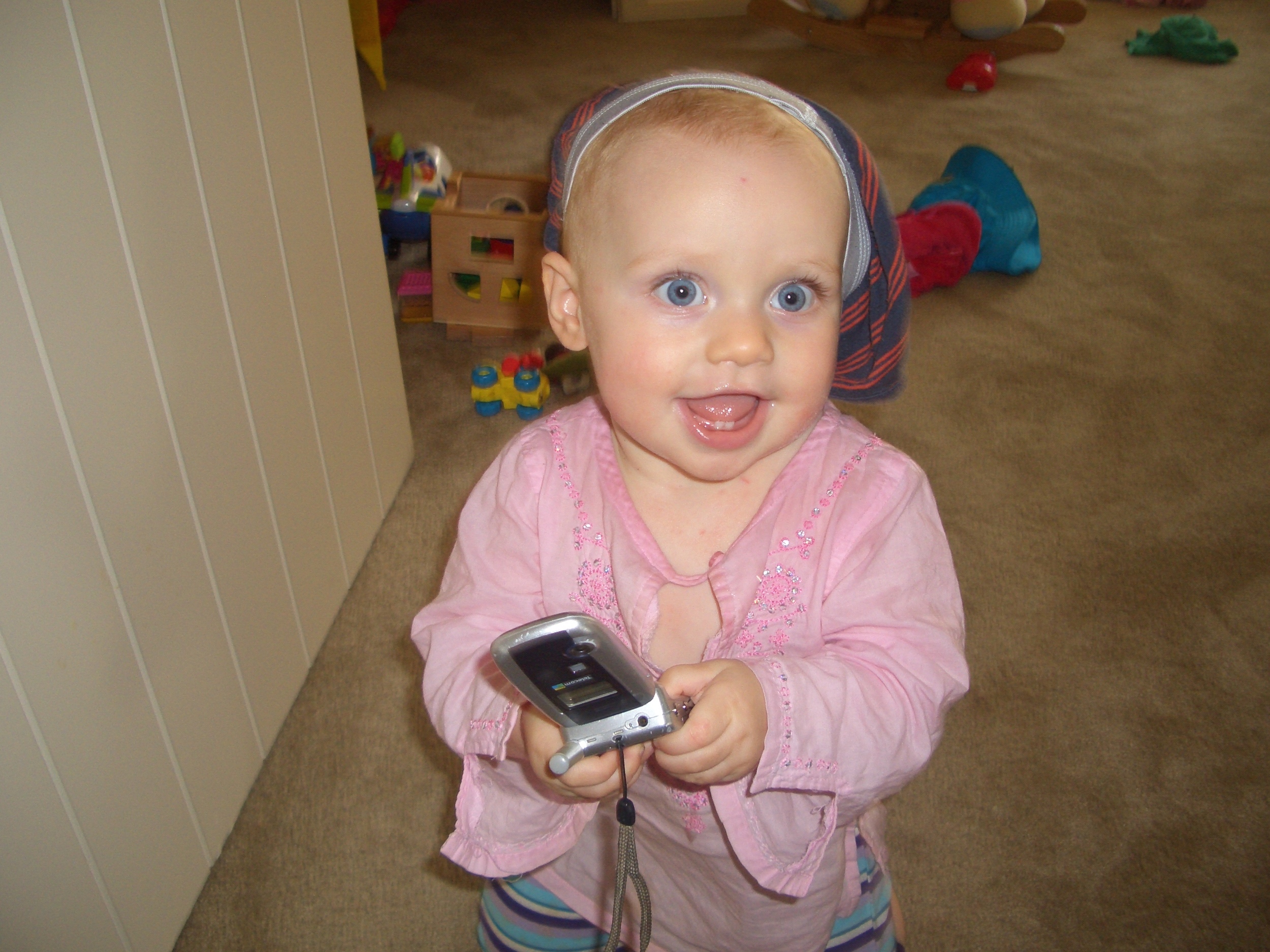 Kaya employs tactile and visual learning here - wearing her brother's undies on her head and mum's old phone safe in two hands!