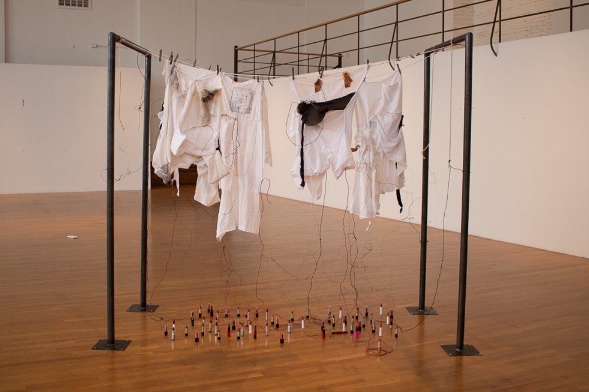 Sister Transistor, 2018. Clothing, lipsticks, wire, pins, clothesline and other media. Size variable. 