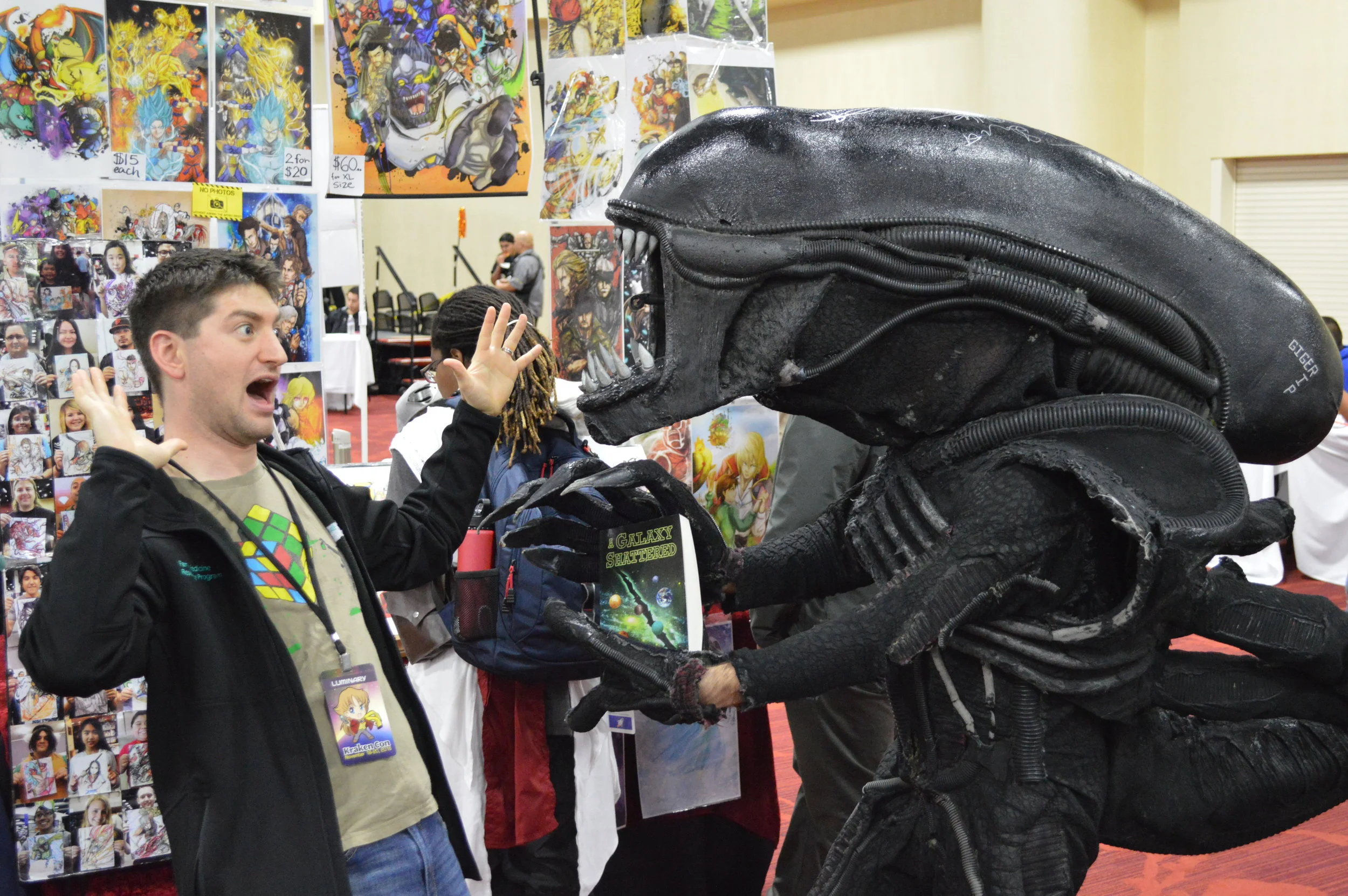 Me being attacked by a xenomorph over one of my books. It was not happy with my sales strategy.