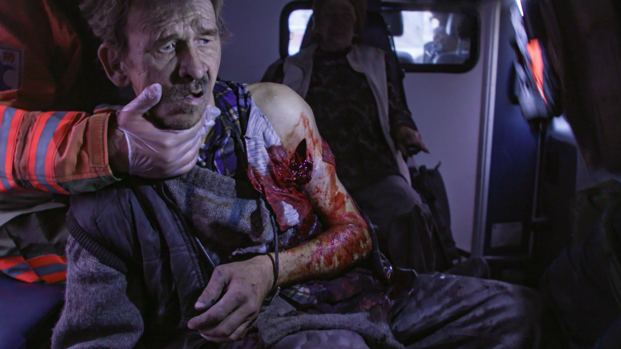 A civilian man is treated for shrapnel wounds as an ambulance speeds to a hospital in Kostyantynivka - screenshot from Channel 4 News short doc