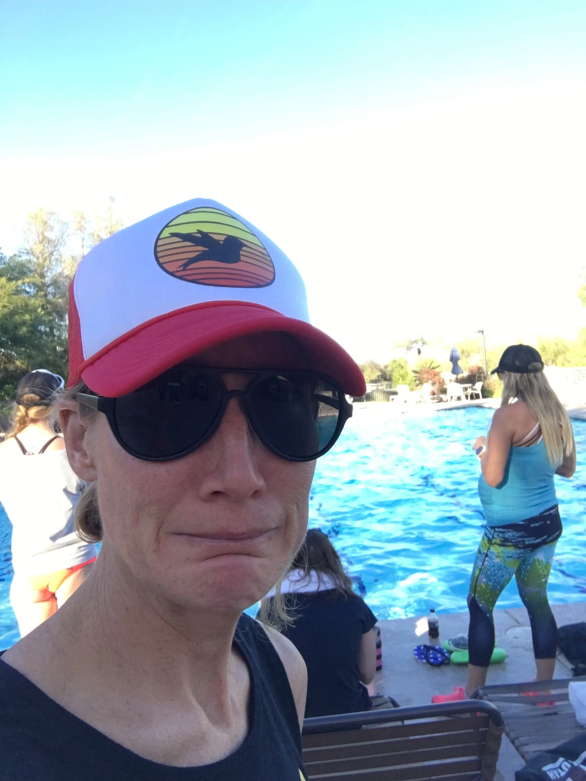 Screen left, a nervous triathlete about to jump into a swim skills session at Triathlon Camp in January under the watchful eye of her super-swimmer coach, screen right.