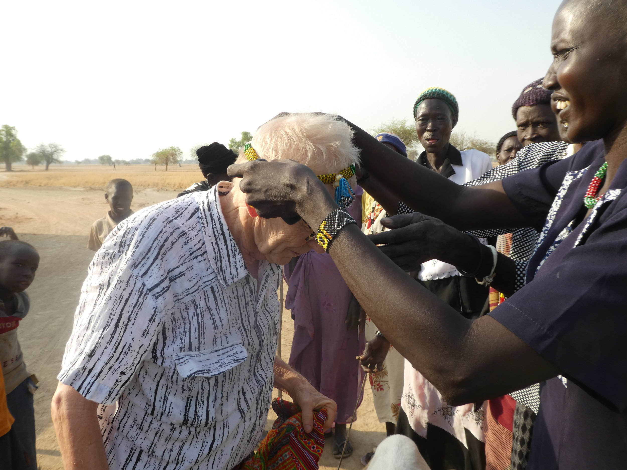  Bill receiving a beaded necklace from one of the mothers whose daughter will be attending school in South Sudan.&nbsp; 