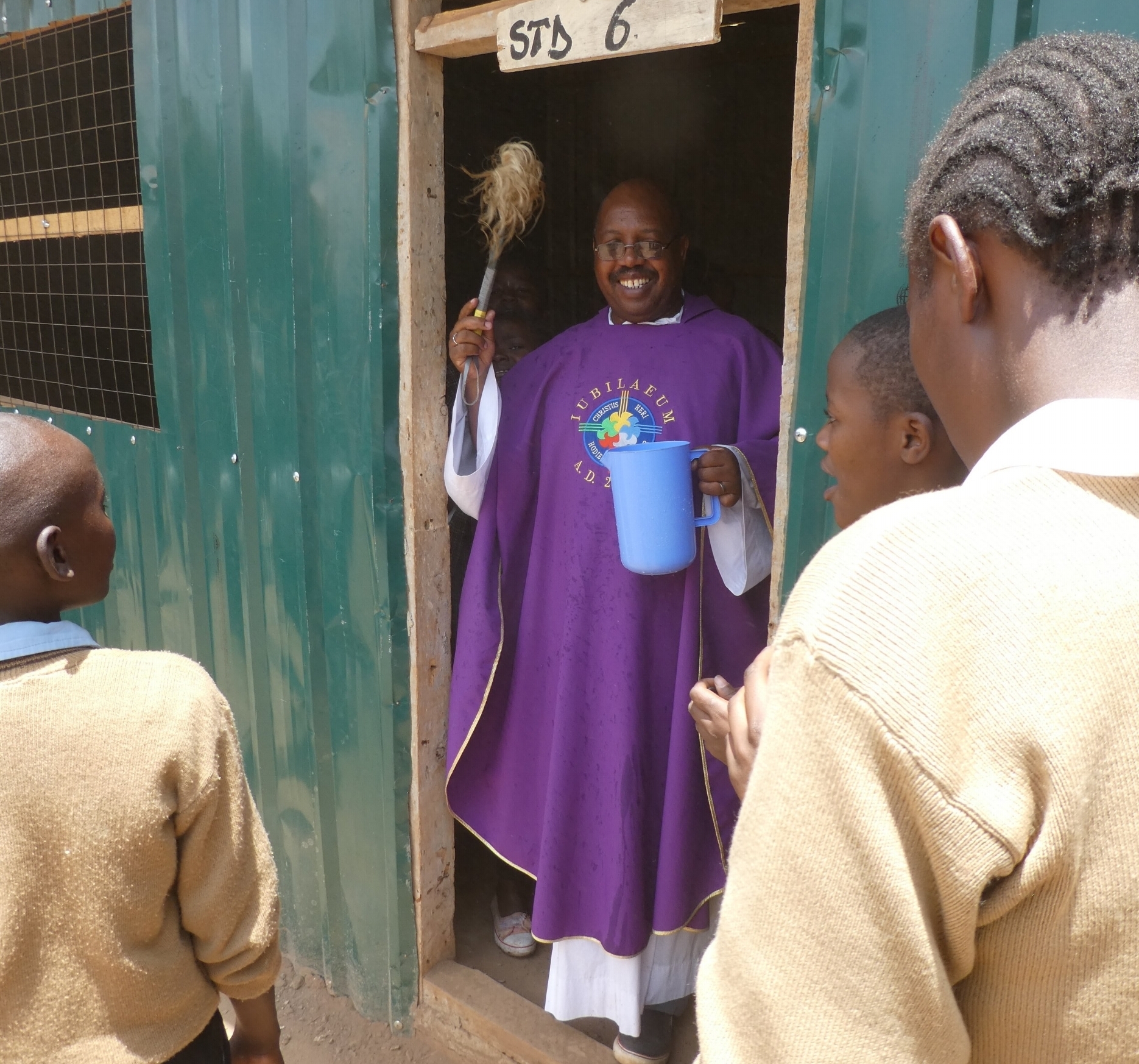 Father David Kamau blessing the new library and science lab 