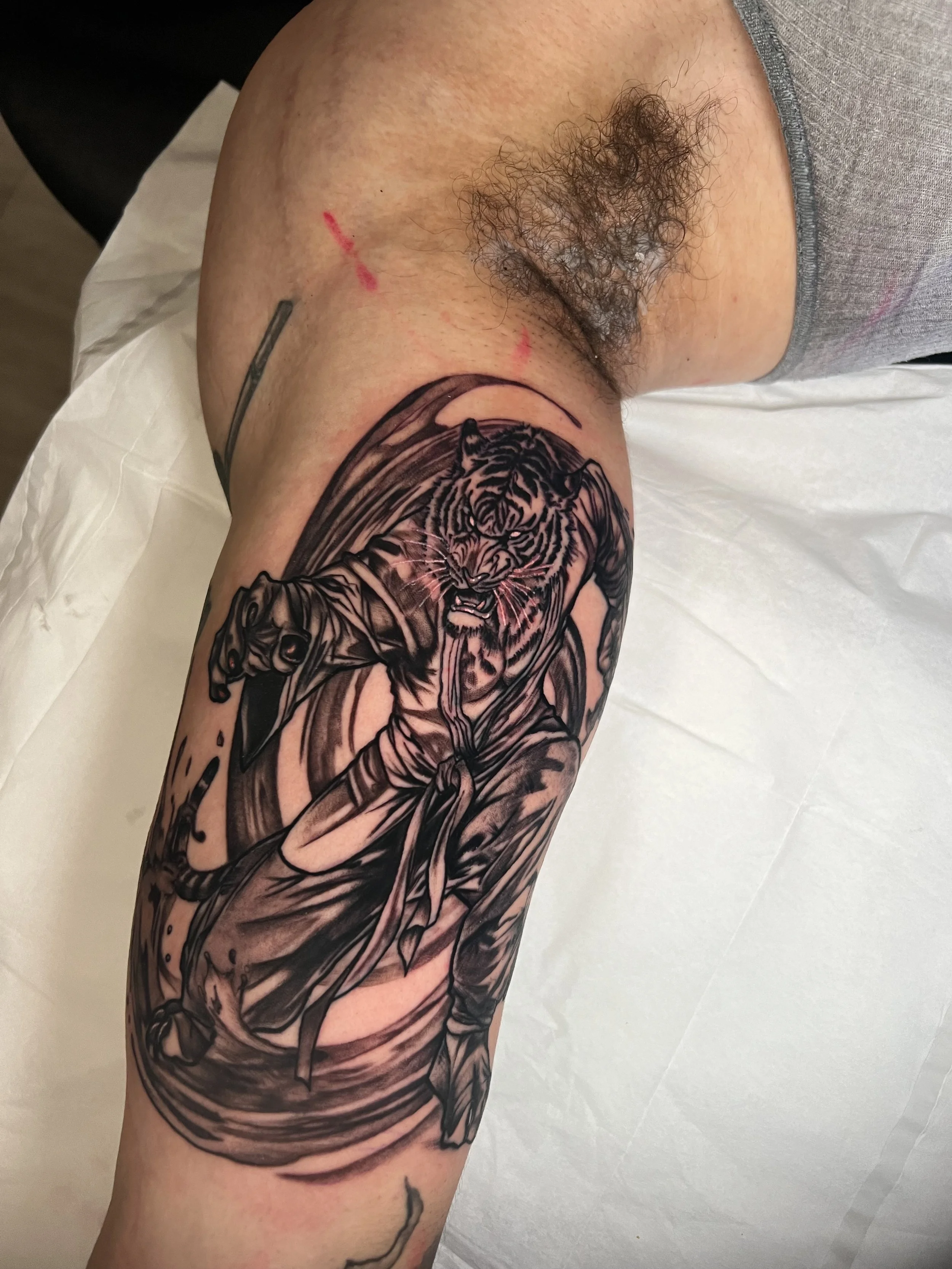 Tiger figure tattoo by Thad Curry