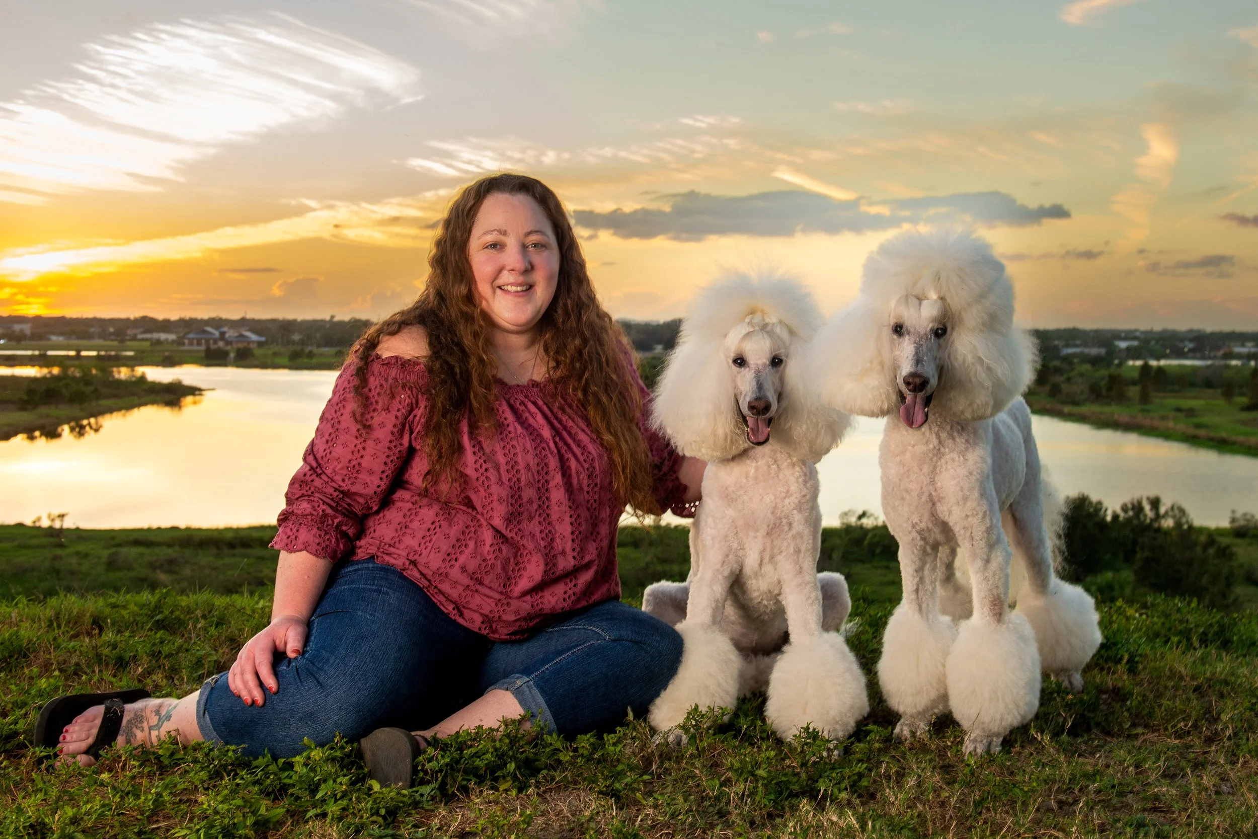 woman with two poodles at sunset in florida