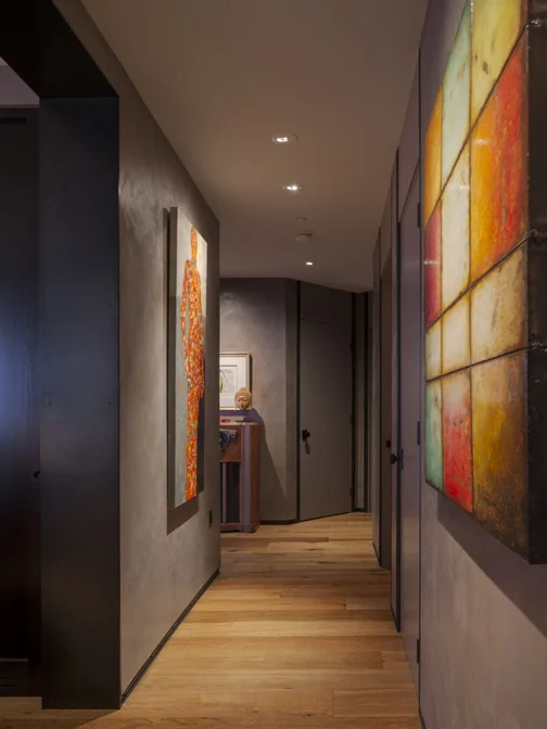 Hallway with metal base and casing, plaster walls, great art and recessed art lighting
