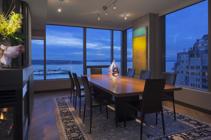 contemporary seattle architectural condo design with reclaimed wood dining table, beautiful art and great view