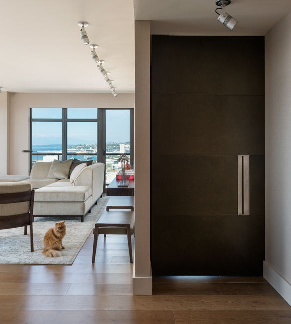 Full height leather wrapped door with custom fabricated metal pull for Master Bedroom Remodel