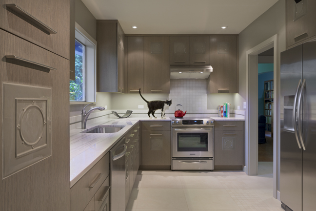 Seattle Kitchen Remodel with new back splash, counters and custom inlay oak cabinets and a cat on the counter 
