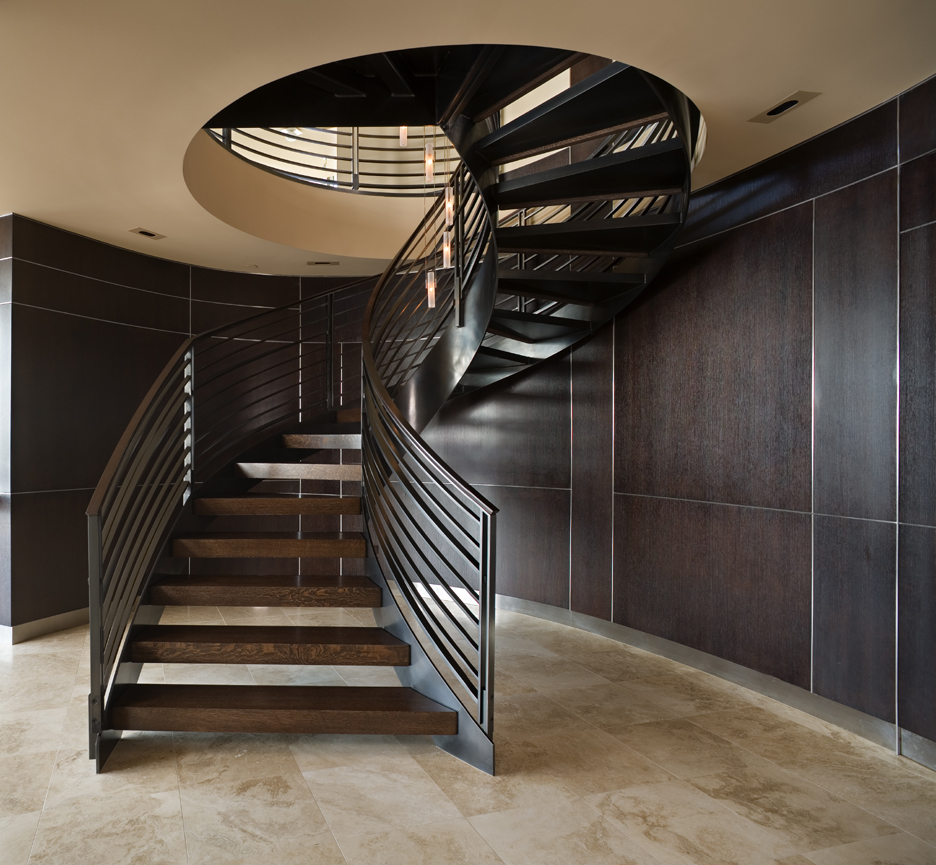 Seattle spiral stair, curved wood walls with hidden doors beyond, travertine floor