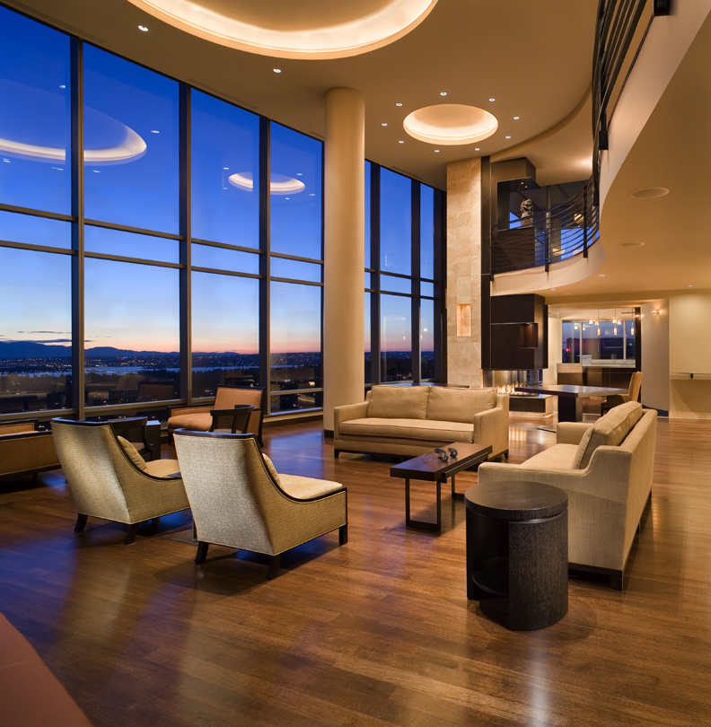 double height Seattle Living Room with hardwood floors, custom recessed ceiling lighting, and a metal and wood fireplace surround