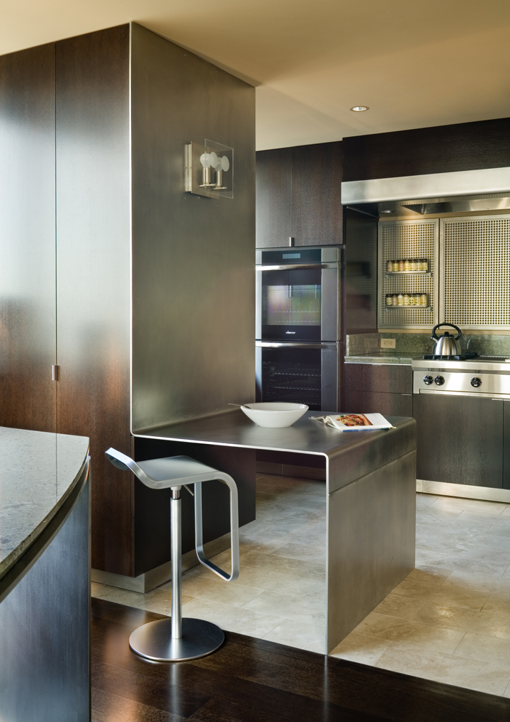 modern Seattle Kitchen Remodel showing stained oak cabinets with custom bent steel counters, hardwood floors and steel splash