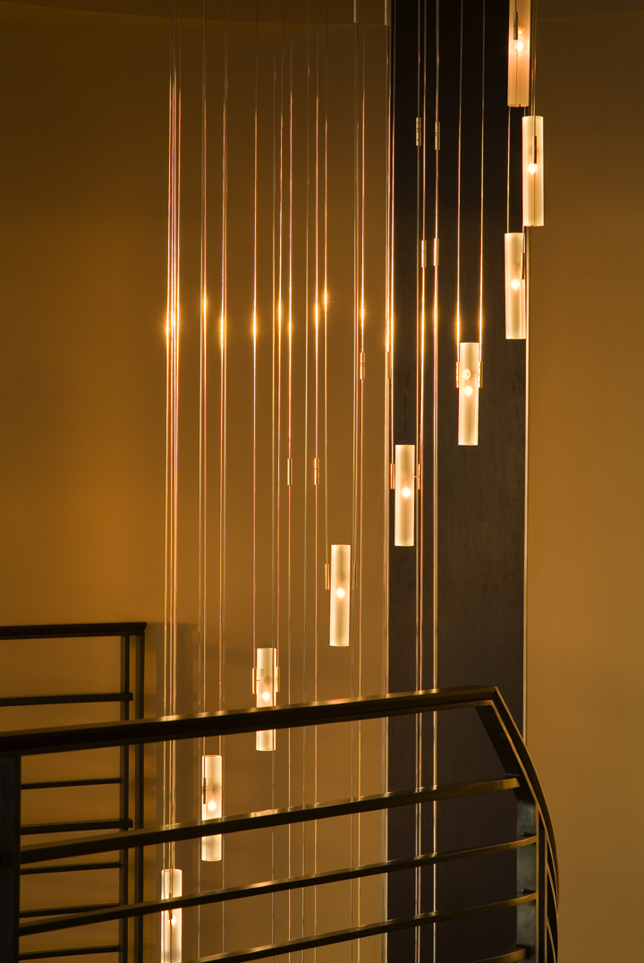 amazing spiral frosted glass and stainless steel chandelier at curved residential staircase