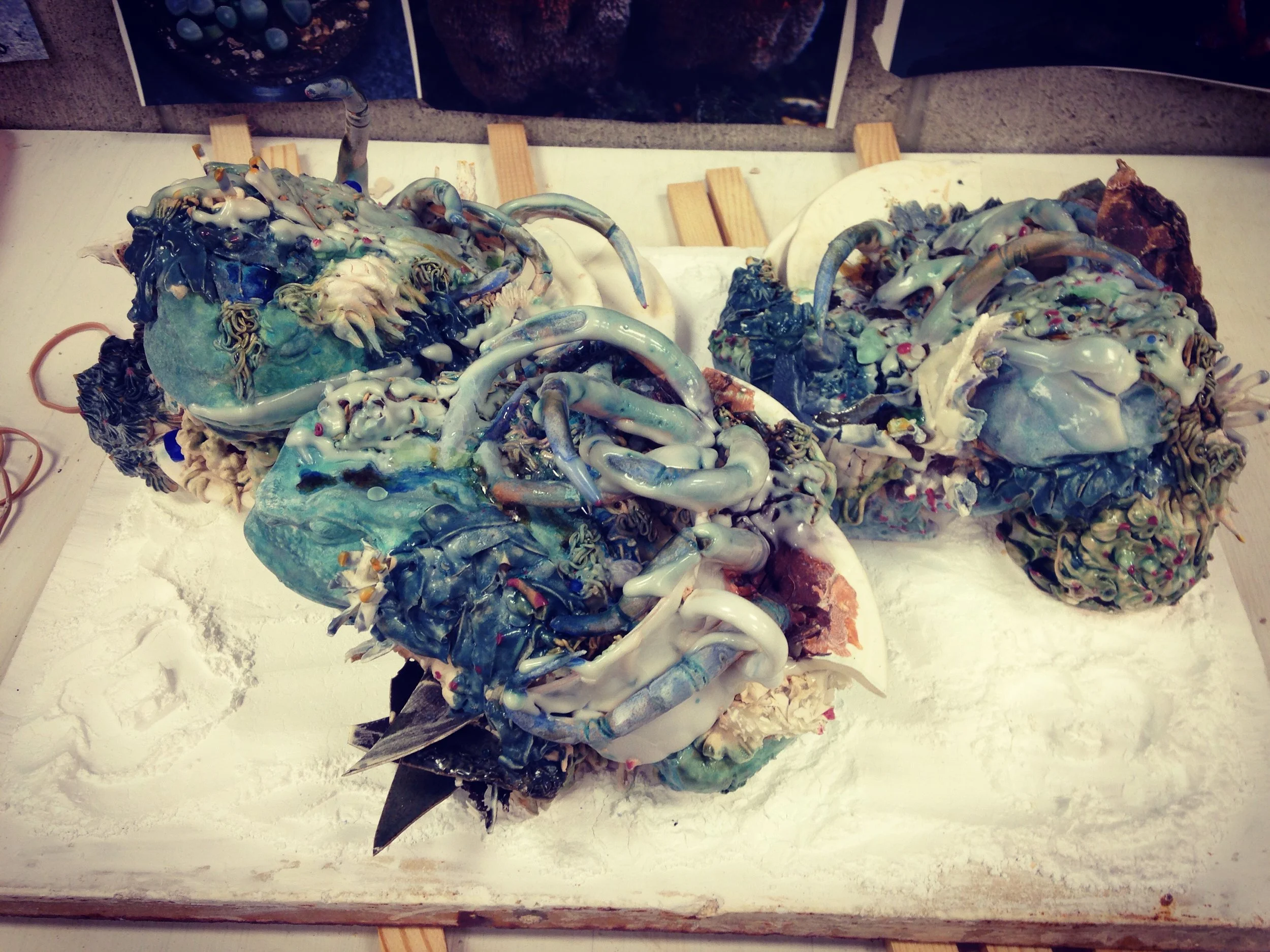 My pieces after the misfire of the kiln. It did not reach temperature, so the pieces are covered in a hazy white wash, which is the clear glaze that did not flux fully.