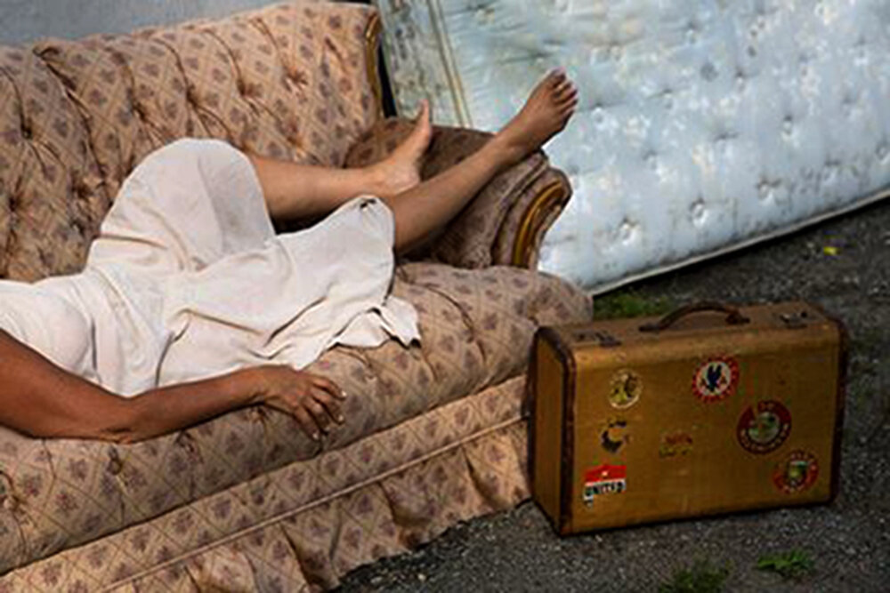 nina on couch wiht suitcase.jpg