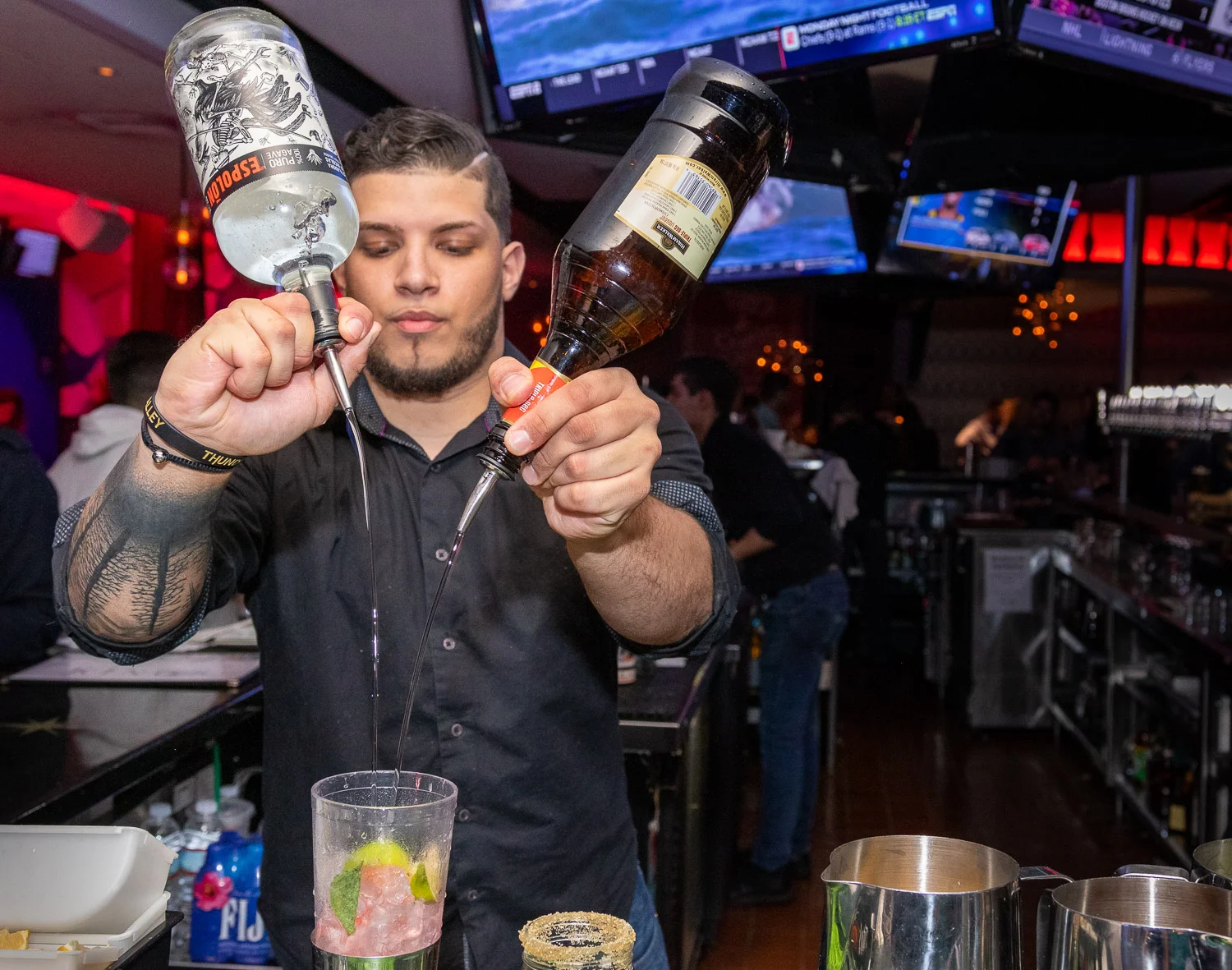 Bartender pouring alcohol