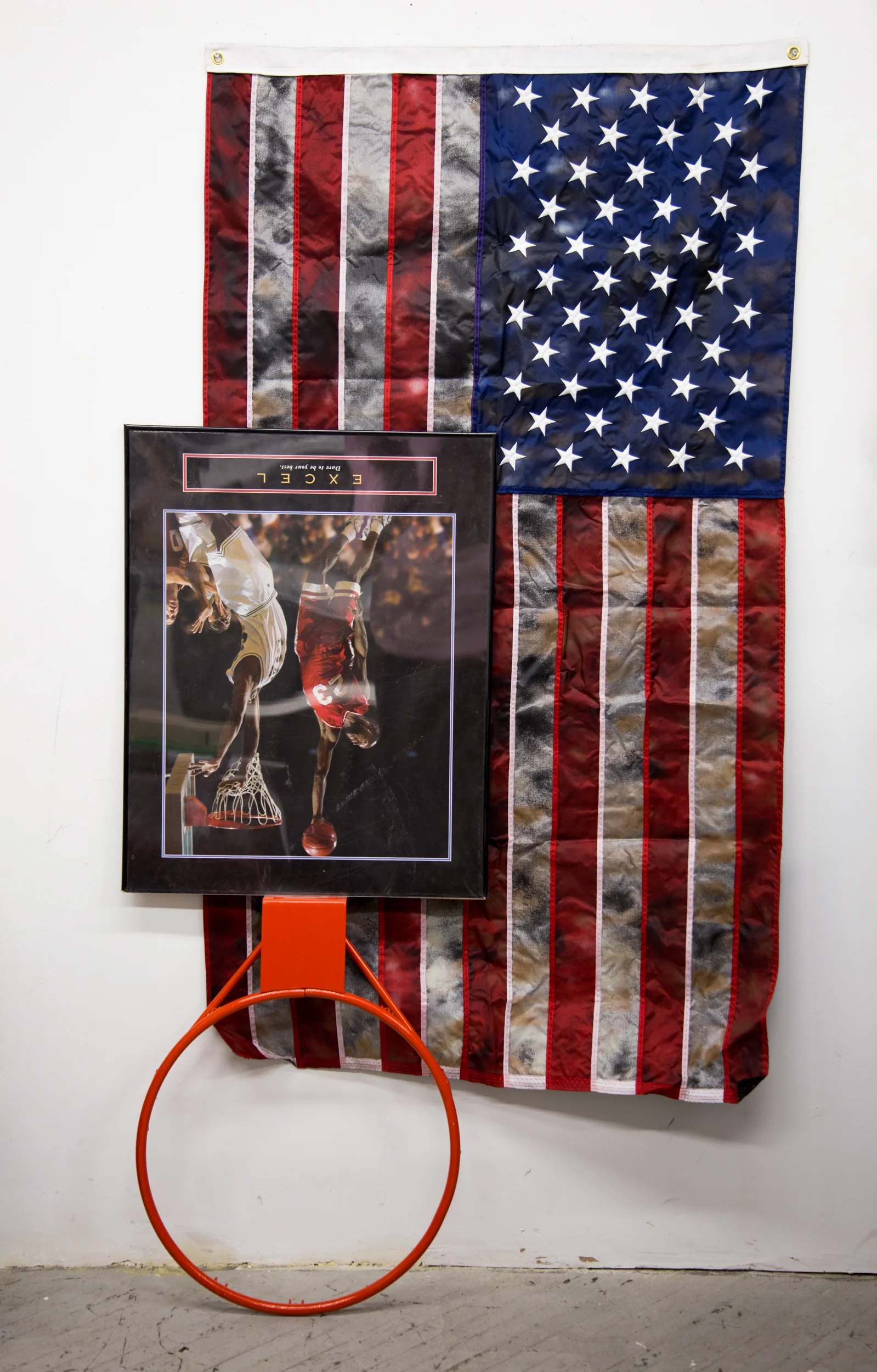 Rindon Johnson Excel, 2016 inspirational poster, basketball rim, spray painted American Flag 6 feet x 4 feet x 4 inches Courtesy of the Artist and Fort Gansevoort