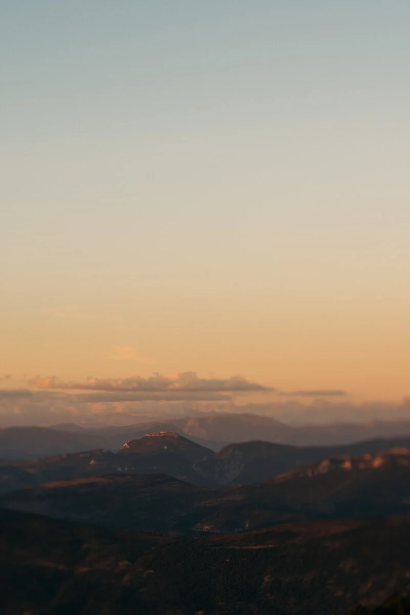 sunset at mont serein orange sky and soft clouds and hills