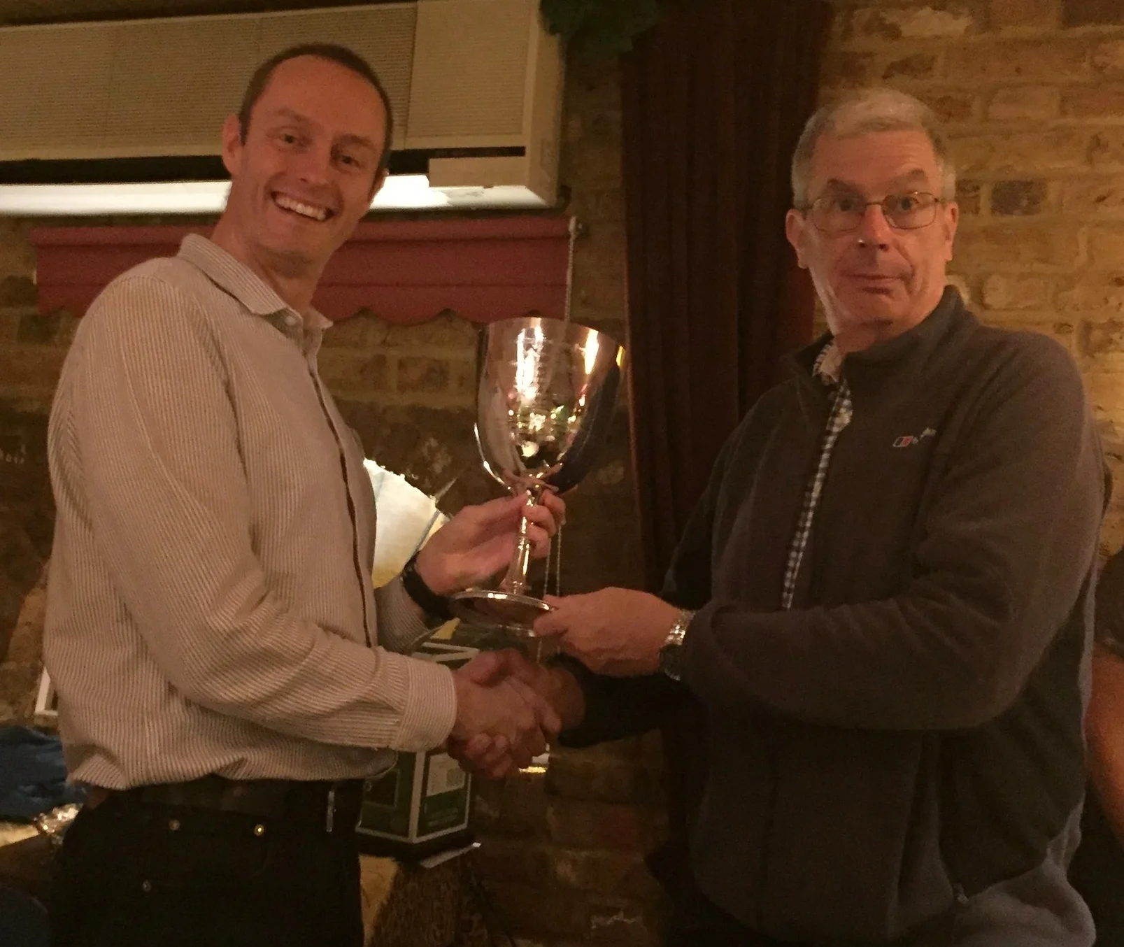Men's mile winner Dave Warren receiving the trophy from President, Paul Hindle