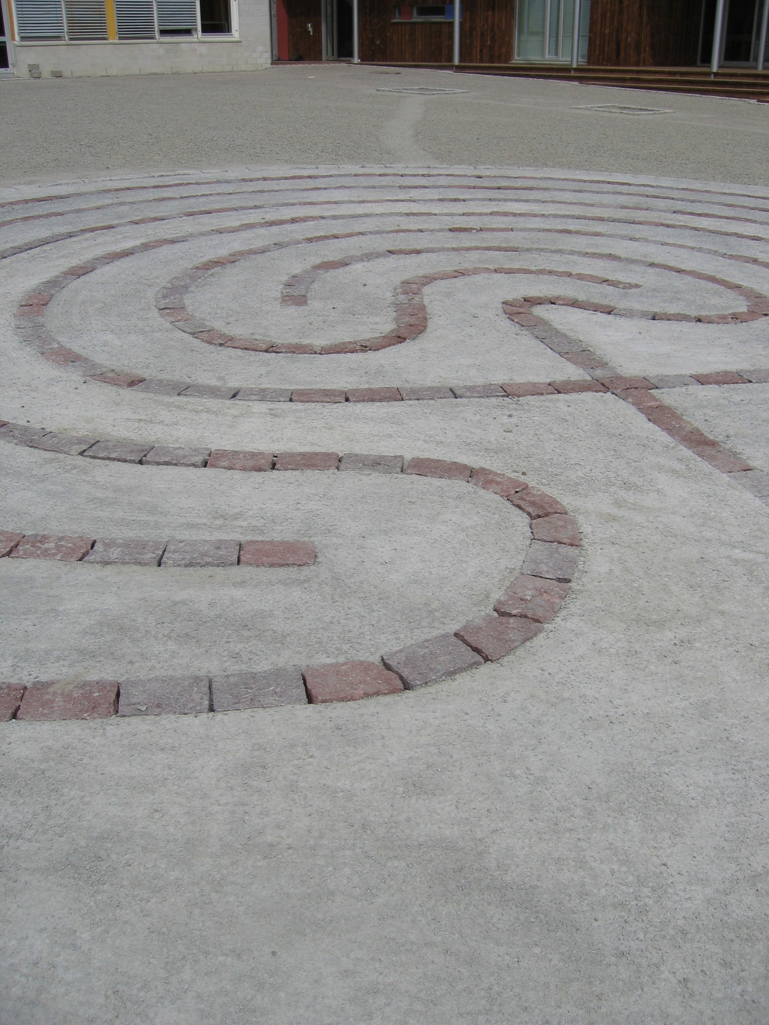   Labyrint i storgatestein og betong som mønster i flata   