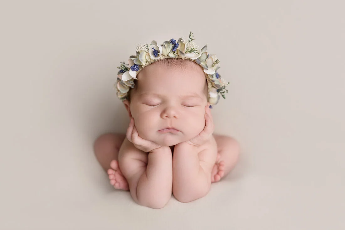 froggy position newborn girl in floral halo