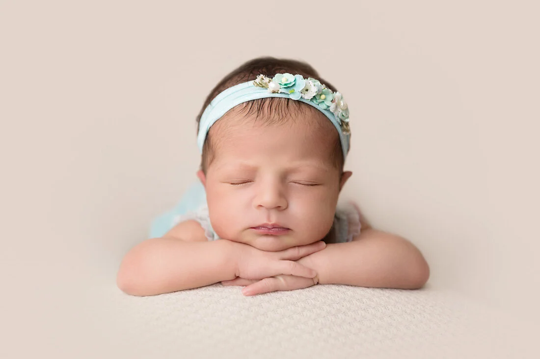 head on hands position newborn posing