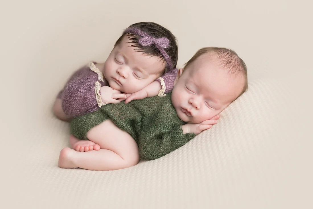 boy girl newborn twins in purple and green
