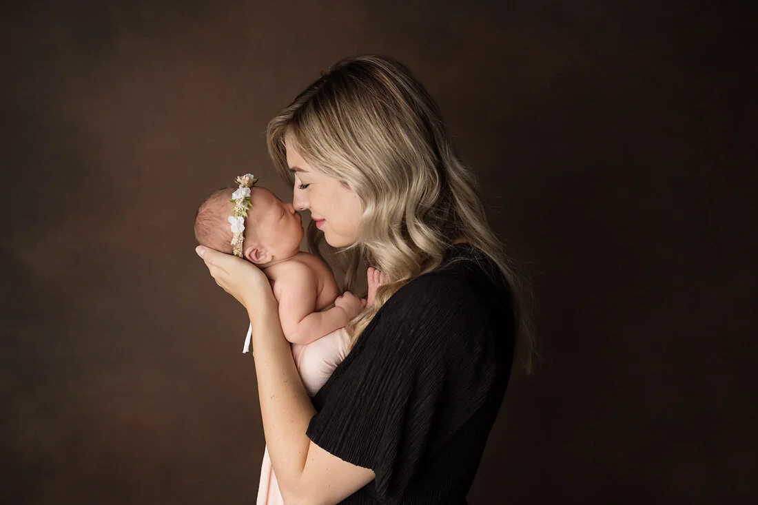 mom and newborn eskimo kiss