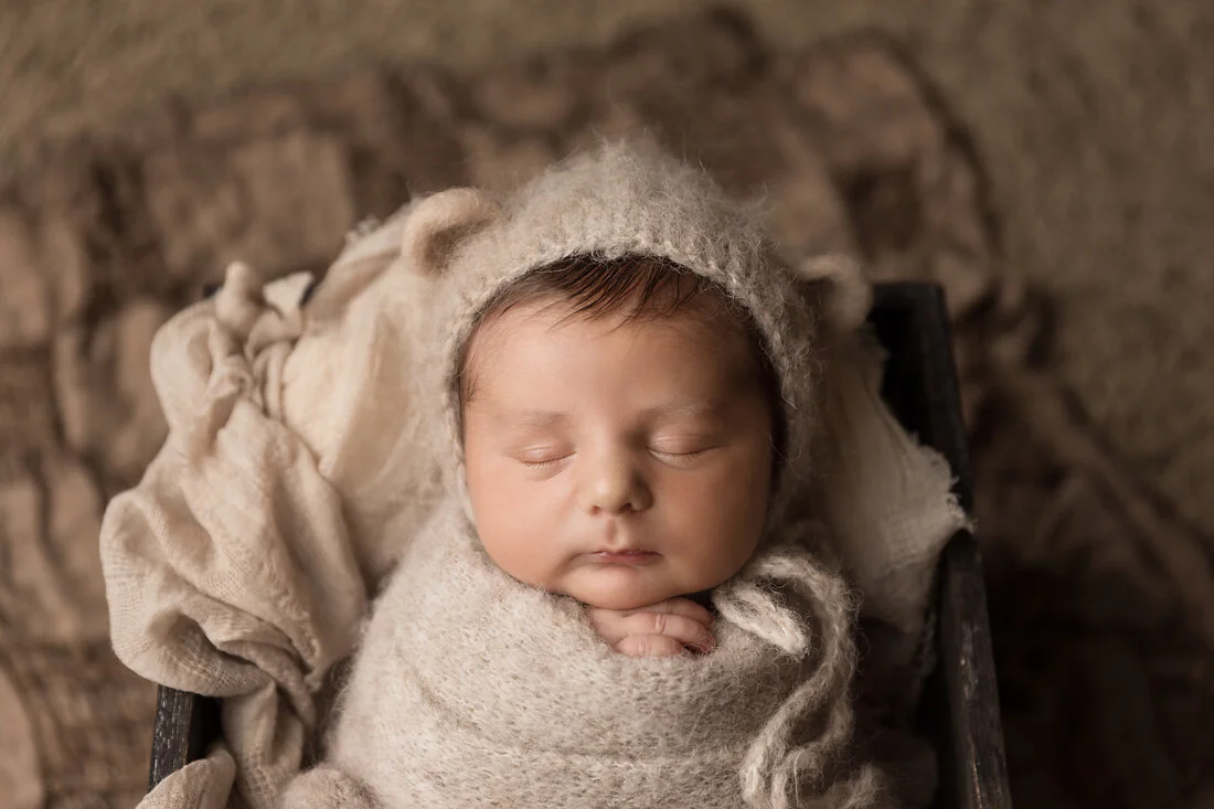 newborn boy in bear bonnet