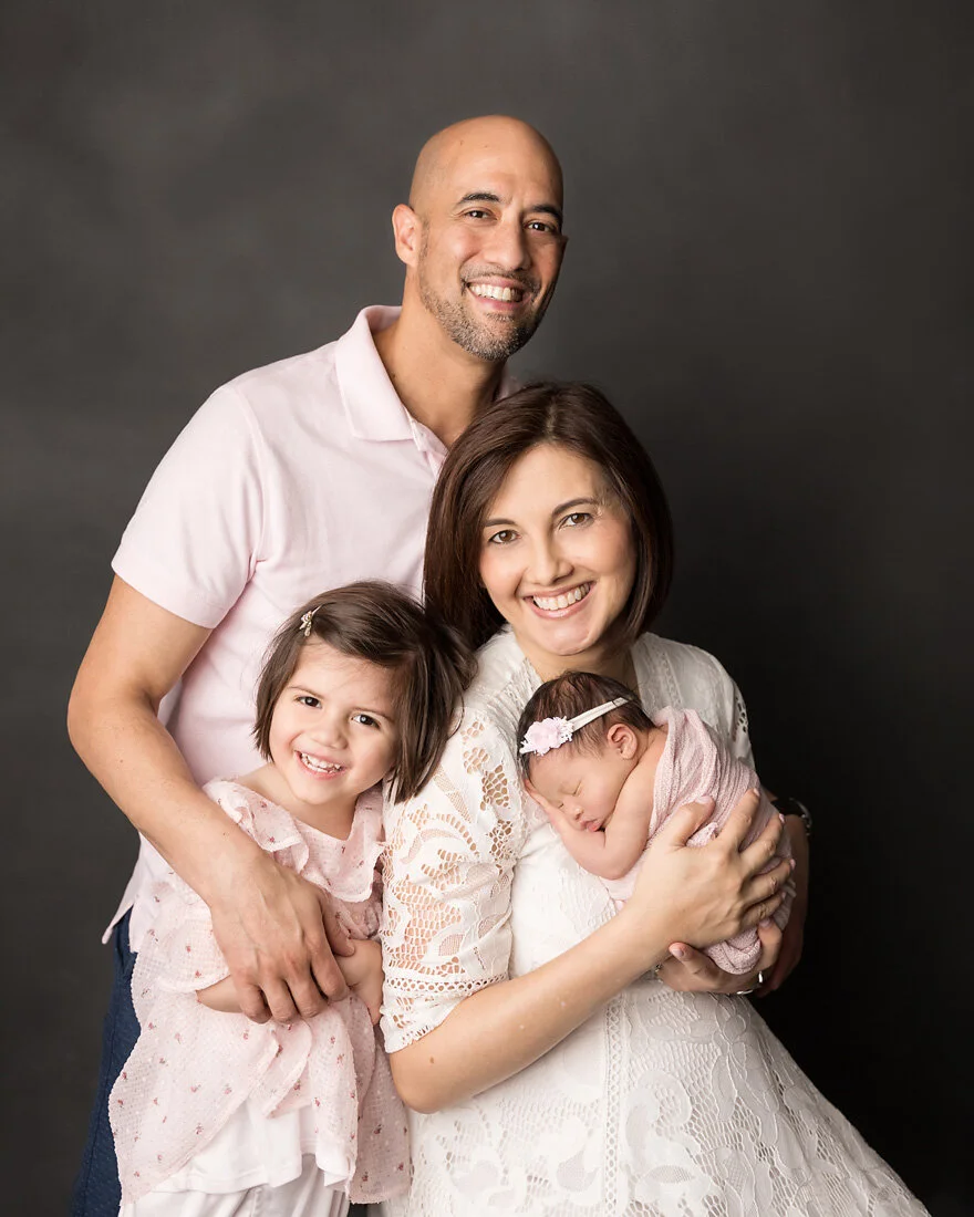 family of four with newborn baby