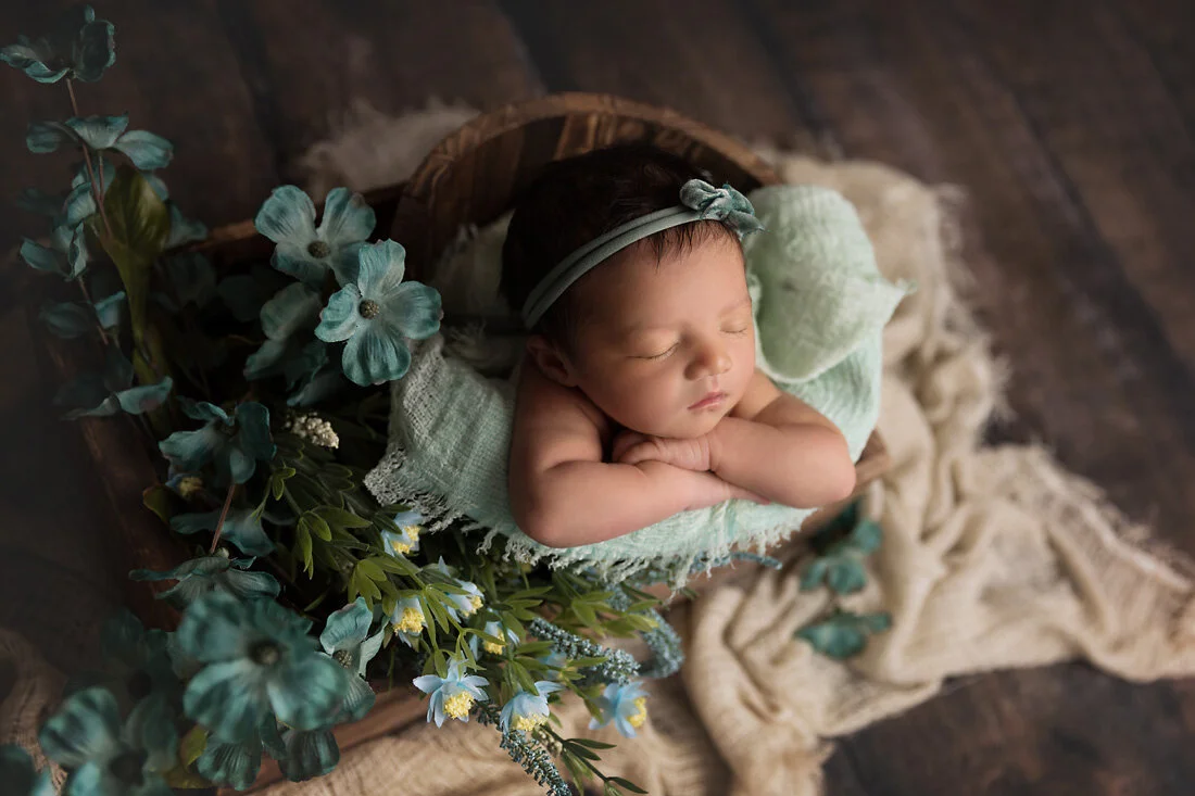 teal flowers and newborn in bucket prop