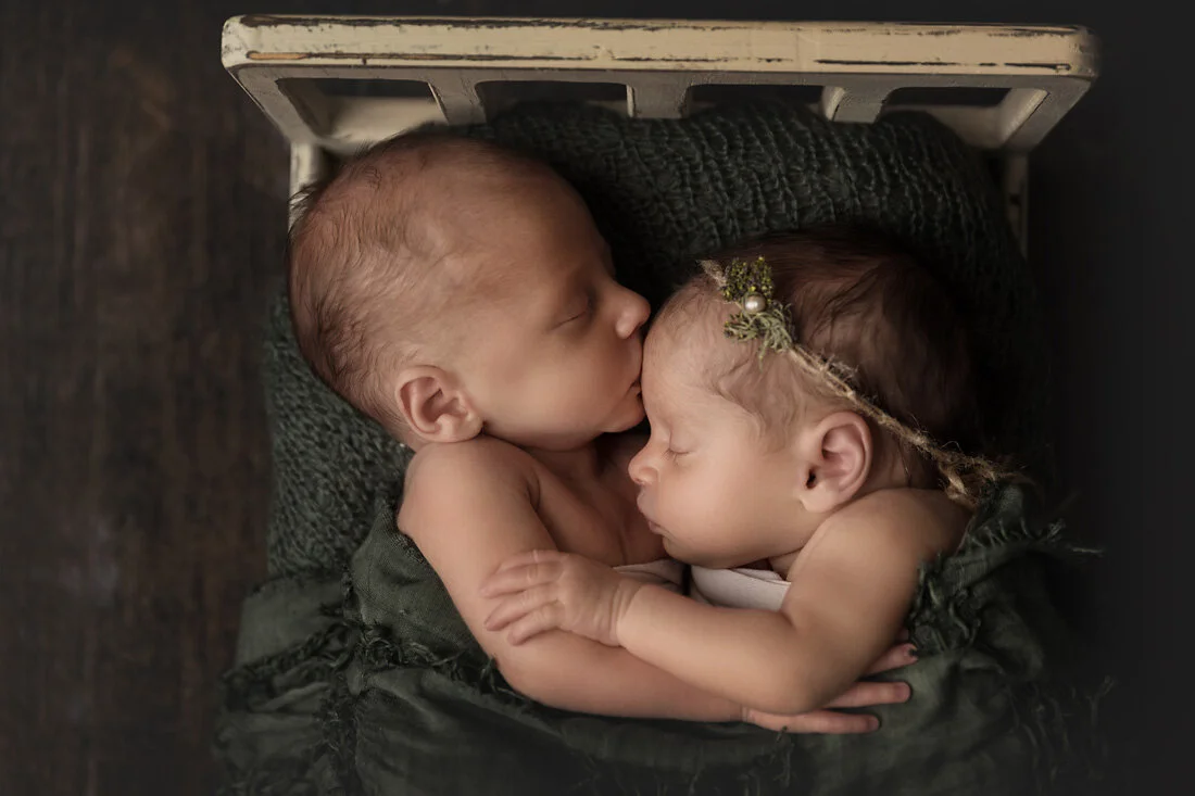 boy girl newborn twins in bed kissing