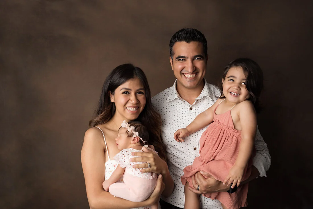 family of four with newborn girl