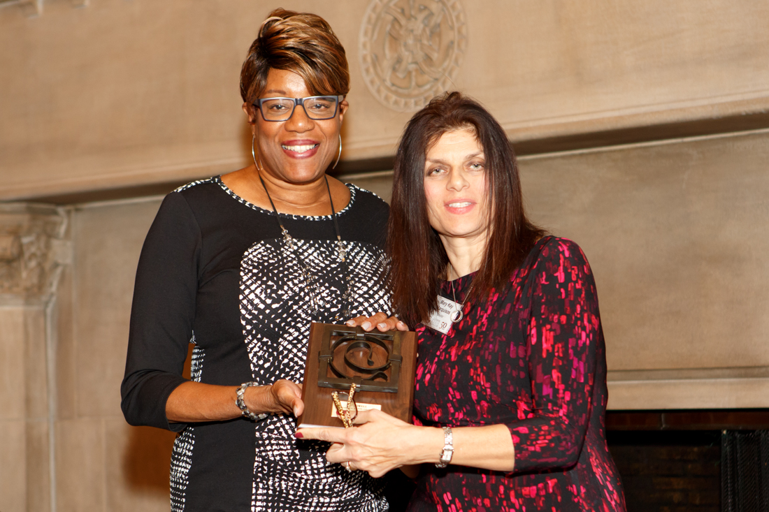 Ald. Pat Dowell accepting award from Mary Kay Marquisos