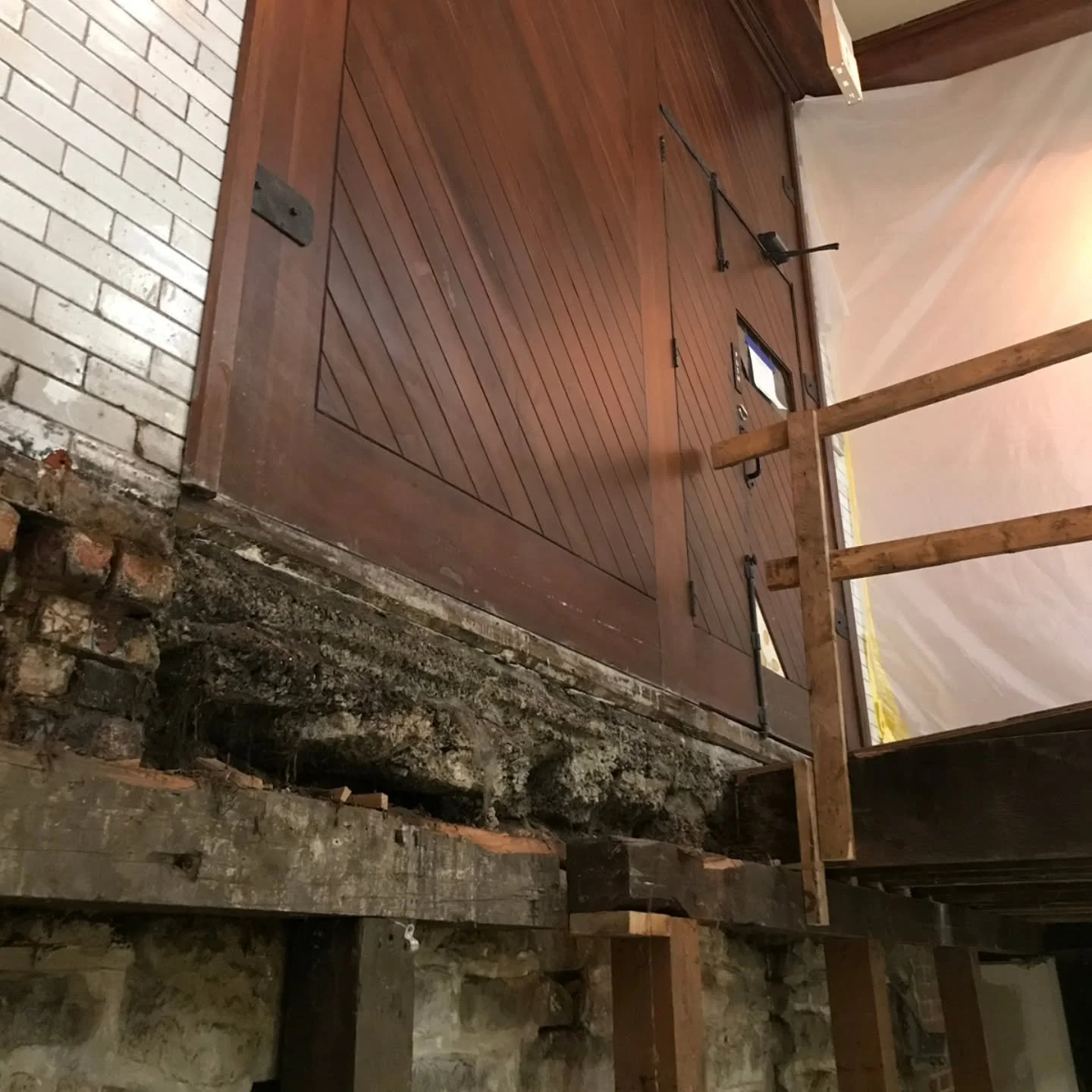 Work is proceeding on our new accessible ramp inside the 18th Street entrance to the coach house. This view is taken from the sub-basement looking up towards the door, through the opening cut into the floor where the ramp will be constructed. Our tha