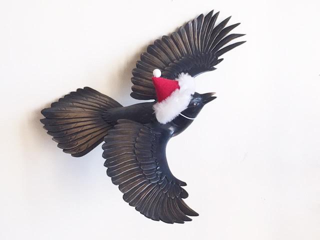 Beautifully detailed jay bird sculpture proudly displaying his holiday finery.