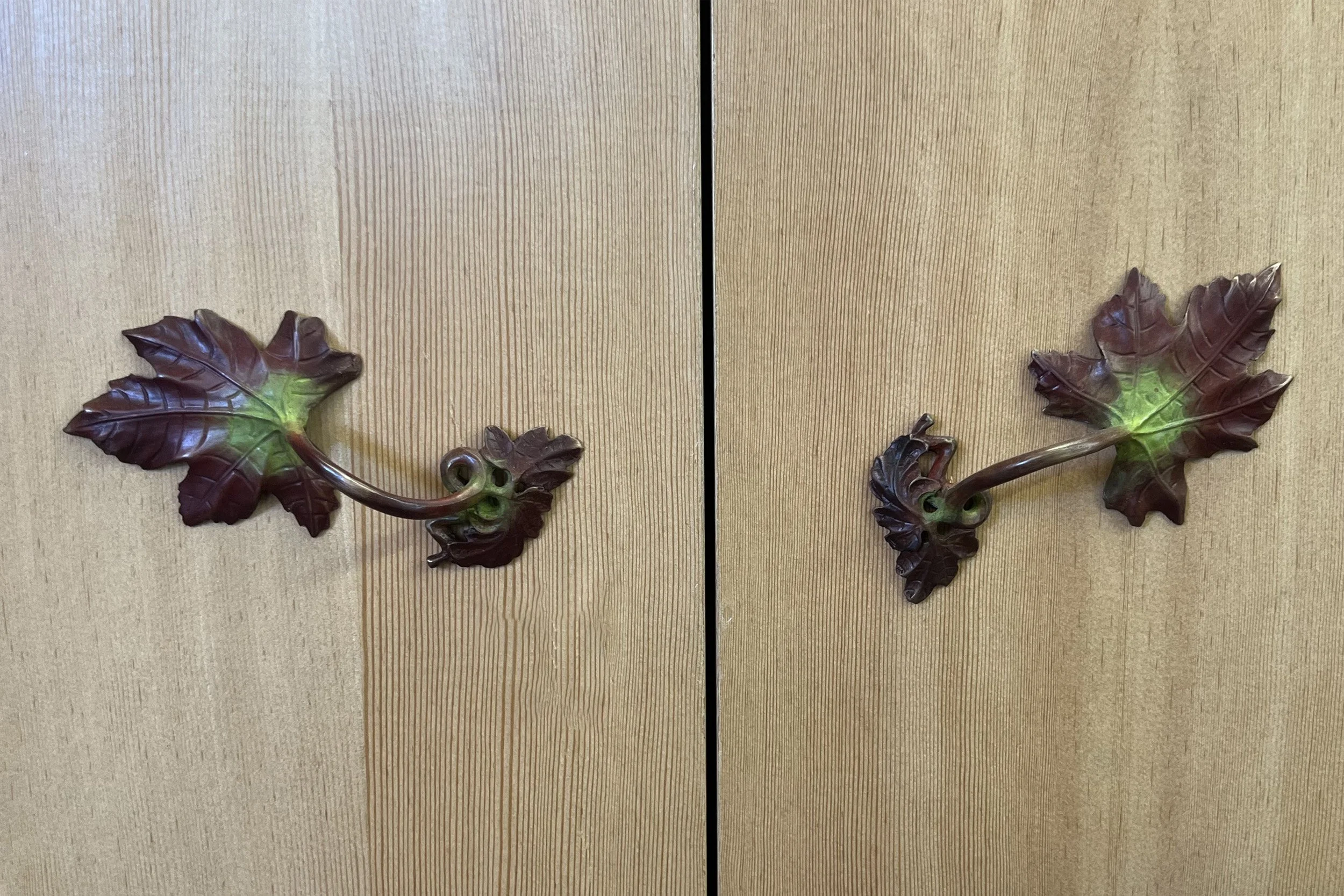 Hot patina bronze vine cabinet pull with red, green and brown autumn leaf tones, handcrafted using cupric ferric nitrate and torch-applied heat.