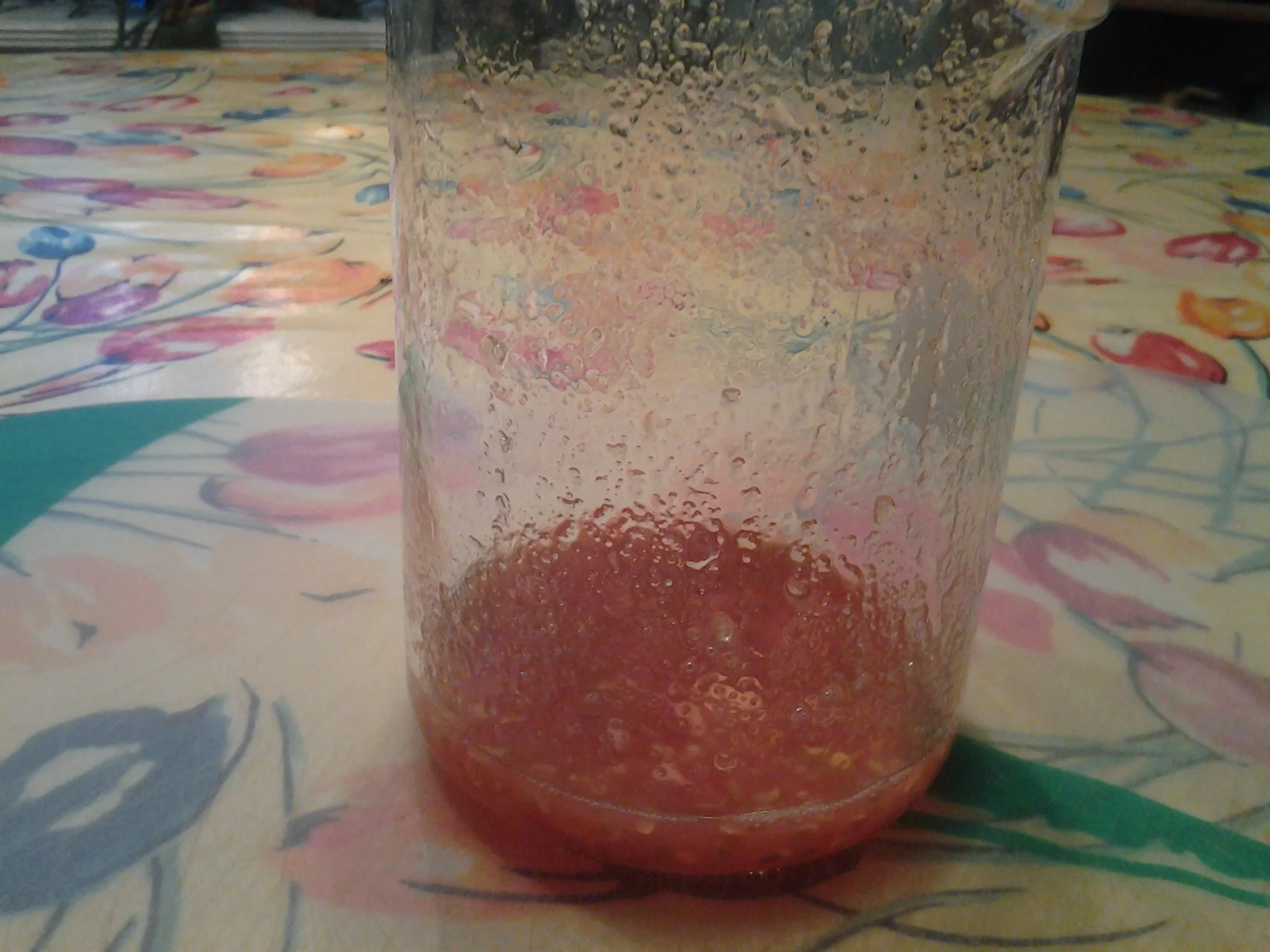2. Scoop out seeds (plastic spoon works well). Transfer seeds and attached pulp to a disposable tall plastic cup.