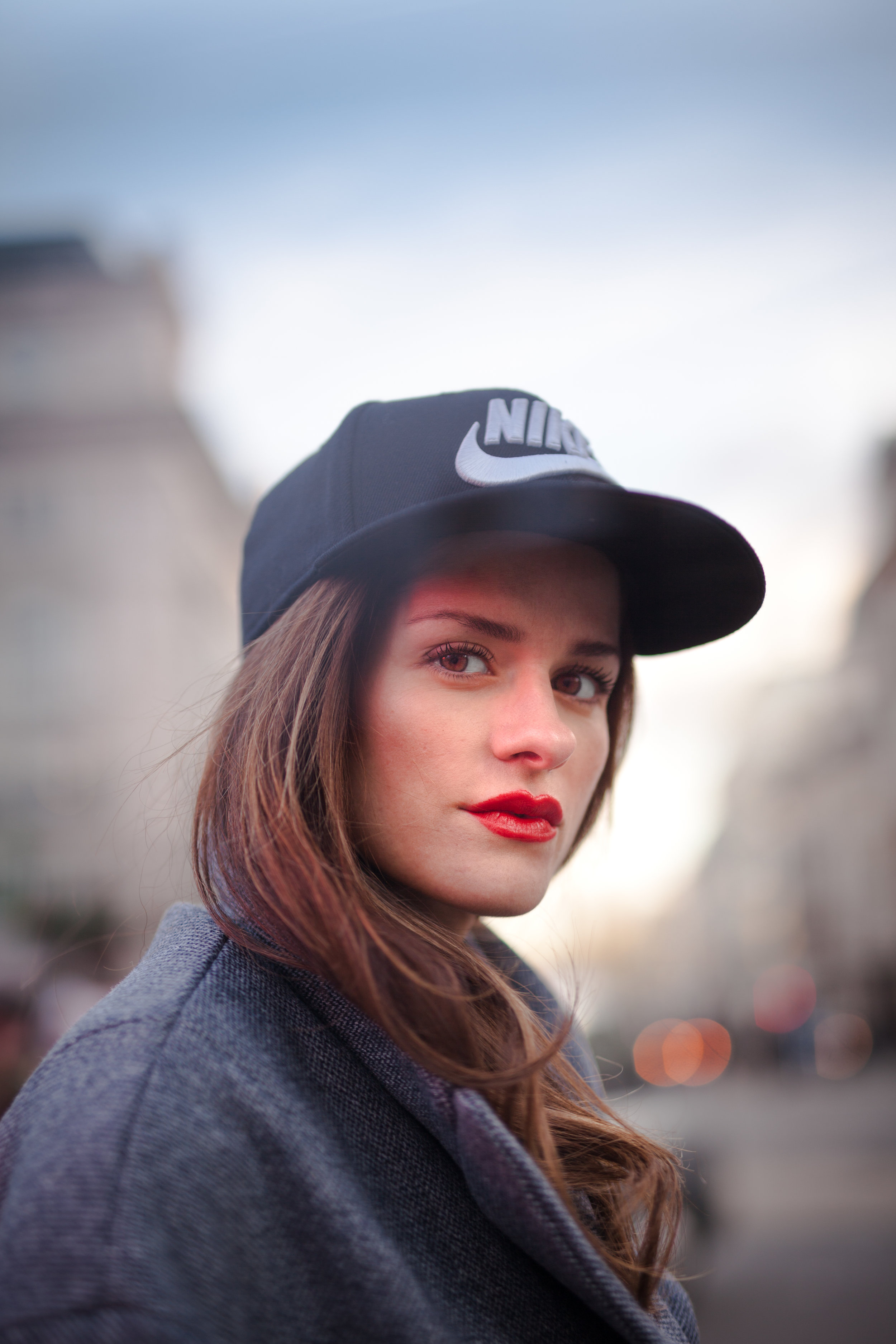 Baseball cap wearing girl poses for lifestyle photo-shoot in London Uk