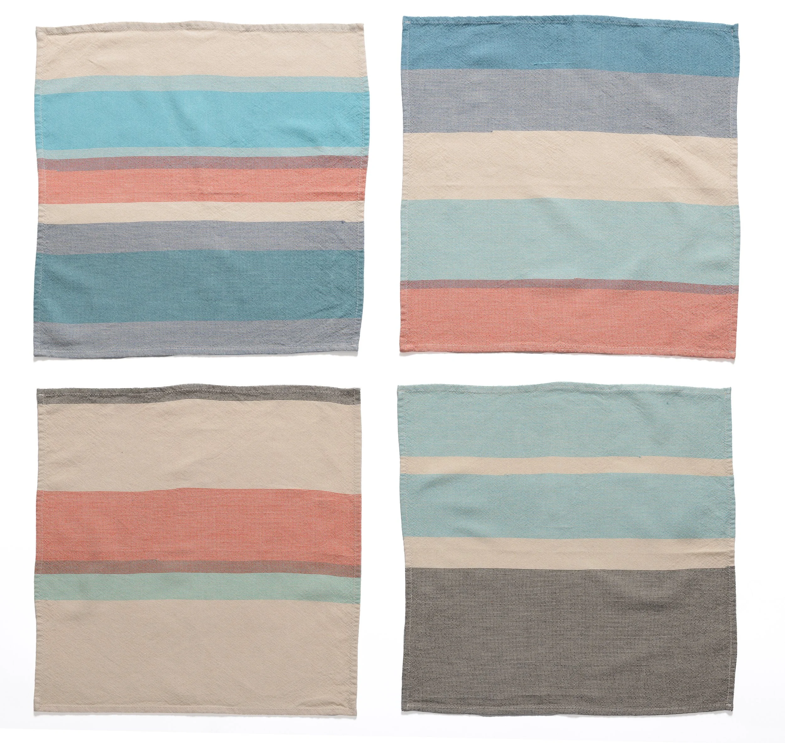 Grid of 4 multi-colored napkins with variegated striping on white background