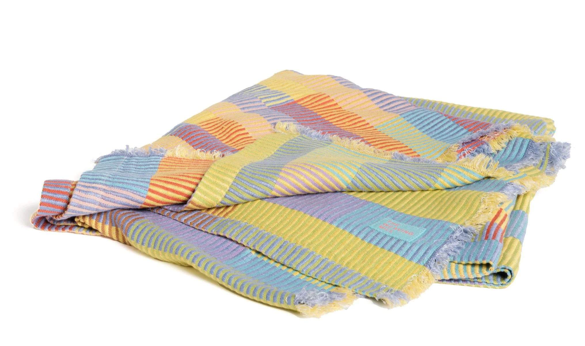 Multicolored blanket folded on a white background