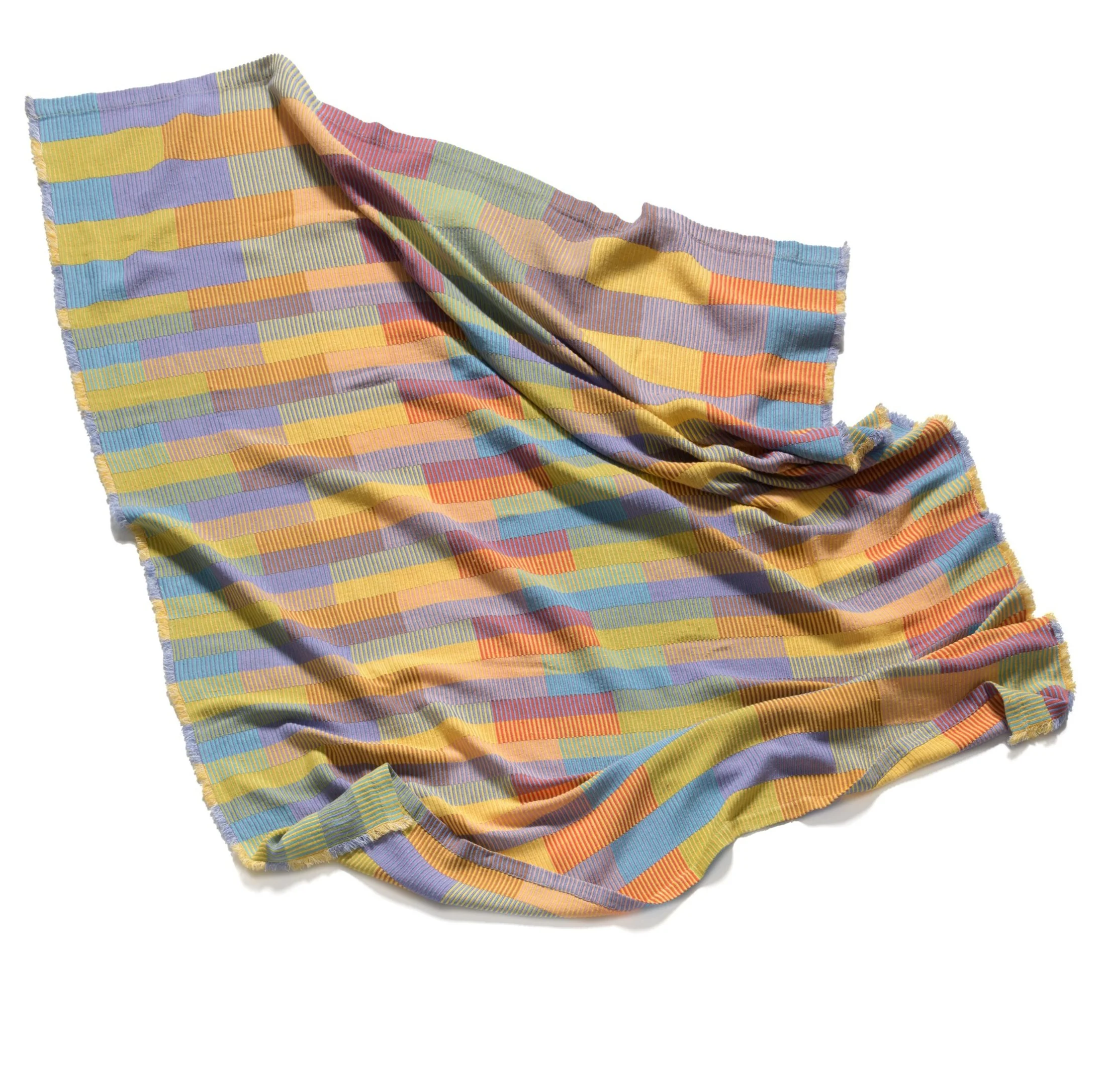 Multicolored blanket laying on a white background